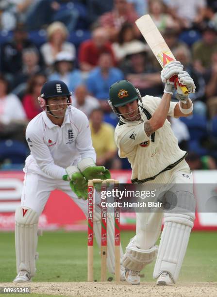 Michael Clarke of Australia hits out watched by Matt Prior of England during day three of the npower 1st Ashes Test Match between England and...