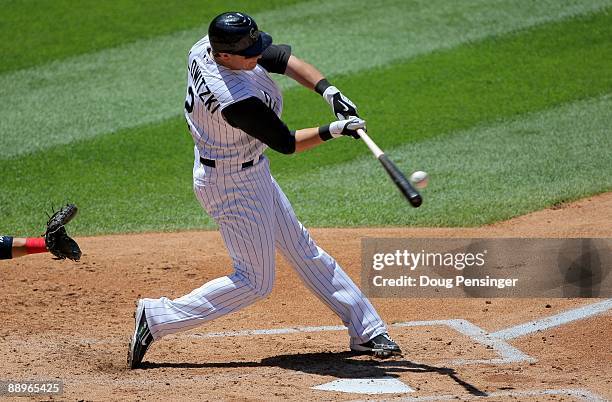 Troy Tulowitzki of the Colorado Rockies makes contact as he takes an at bat against the Washington Nationals during MLB action at Coors Field on July...