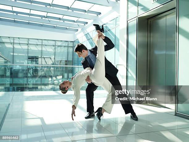 two business people jazz dancing in the office - office romance stock pictures, royalty-free photos & images