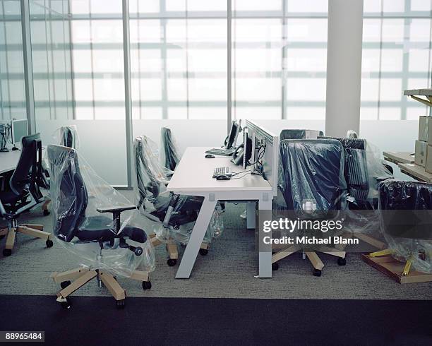 brand new office furniture with plastic wrap - moving office stock-fotos und bilder