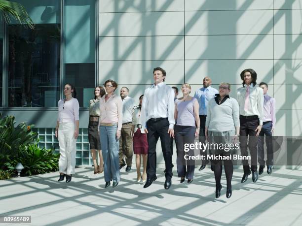 officemates jumping together at the same time - hovering stock pictures, royalty-free photos & images