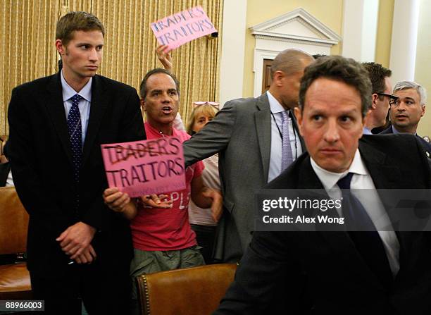 Tighe Barry and Medea Benjamin of anti-war group Code Pink protest to U.S. Secretary of the Treasury Timothy Geithner during a joint hearing before...