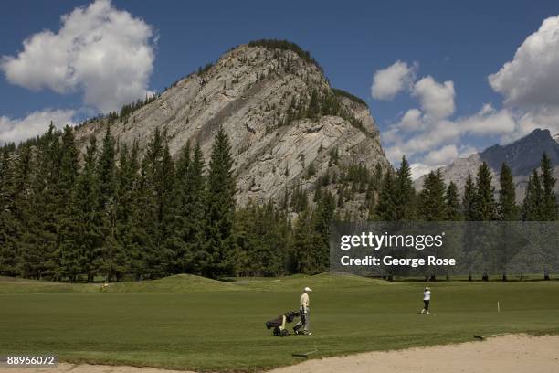 Golfers work their way along the wide, green fairways at the Fairmont Banff Springs golf course as seen in this 2009 Banff Springs, Canada, summer...