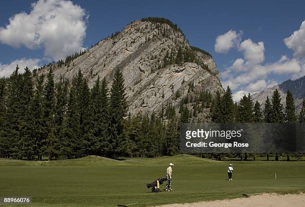 Golfers work their way along the wide, green fairways at the Fairmont Banff Springs golf course as seen in this 2009 Banff Springs, Canada, summer...