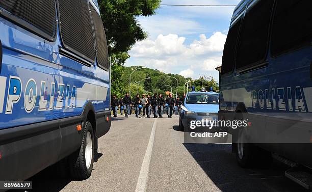 Police checkpoint is pictured as protestors demonstrate in the quake-hit Italian town of L'Aquila where a G8 summit is taking place, on July 10,...