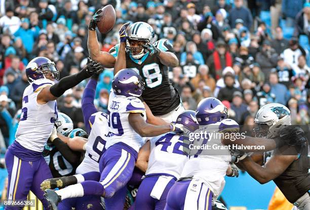 Jonathan Stewart of the Carolina Panthers leaps into the end zone to score the game-winning touchdown against the Minnesota Vikings during their game...