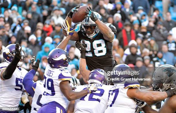 Jonathan Stewart of the Carolina Panthers leaps into the end zone to score the game-winning touchdown against the Minnesota Vikings during their game...