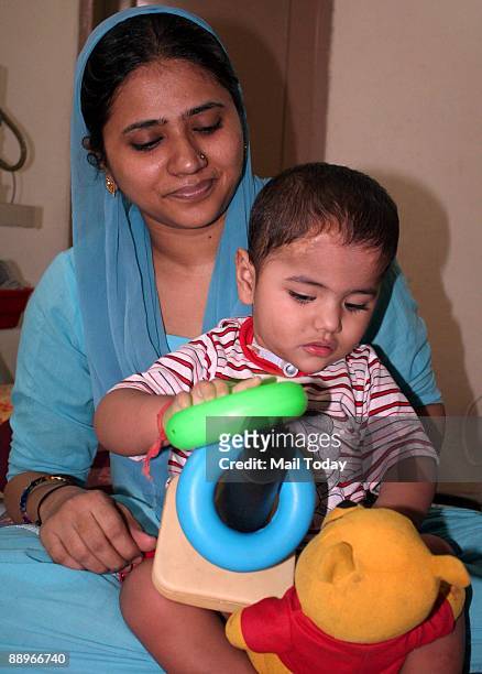 Two-year-old Muaaz Ahmed, who is suffering from a rare respiratory disorder Ondine's Curse, plays with his mother at his residence in Gurgoan,...