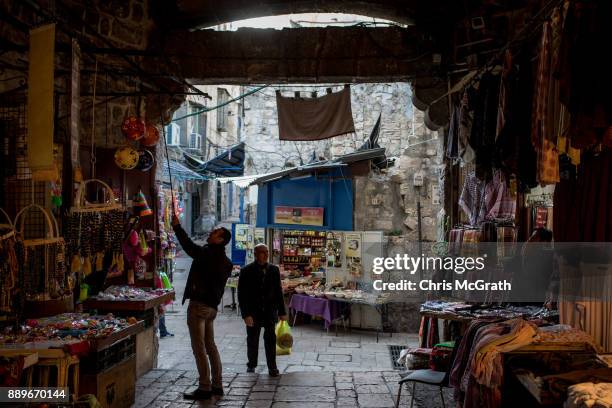 Man prepares to close his store in the Muslim quarter of the Old City on December 10, 2017 in Jerusalem, Israel. In an already divided city, U.S....