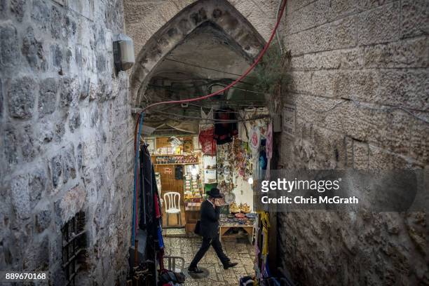 Hasidic man passes shops in the Old City on December 10, 2017 in Jerusalem, Israel. In an already divided city, U.S. President Donald Trump pushed...