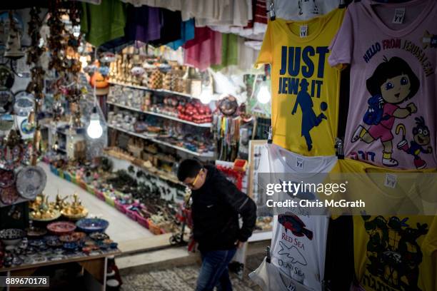 Man walks past souvenir clothing at a store in the Old City on December 10, 2017 in Jerusalem, Israel. In an already divided city, U.S. President...