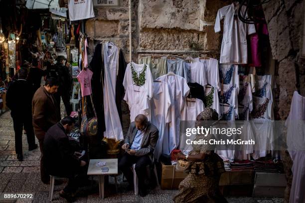 Men play cards in front of a store in the Old City on December 10, 2017 in Jerusalem, Israel. In an already divided city, U.S. President Donald Trump...