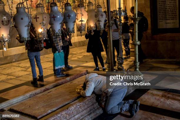 People pray at the Church of the Holy Sepulchre in the Old City on December 10, 2017 in Jerusalem, Israel. In an already divided city, U.S. President...