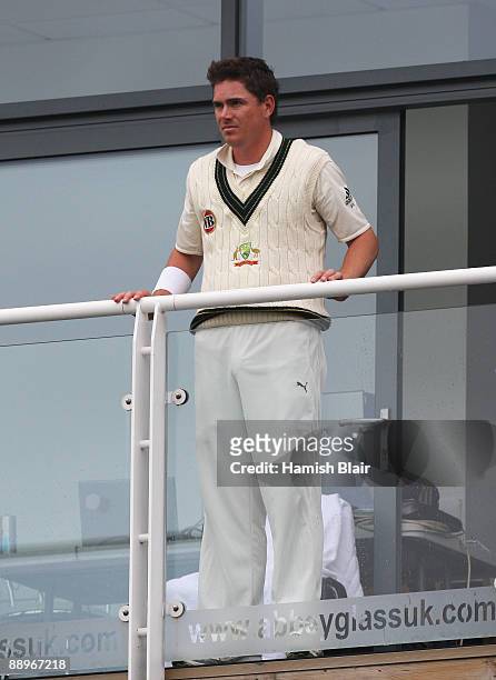 Marcus North of Australia looks on from the team balcony as rain falls during day three of the npower 1st Ashes Test Match between England and...