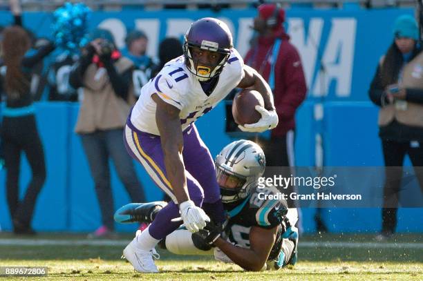 Daryl Worley of the Carolina Panthers tackles Laquon Treadwell of the Minnesota Vikings during their game at Bank of America Stadium on December 10,...