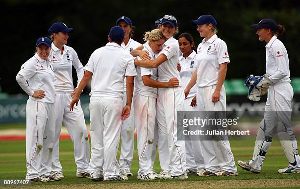 Charlotte Edwards of England hugs Katherine Brunt after she took the wicket of Jodie Fields during Day One of The 1st Test between England Women and...