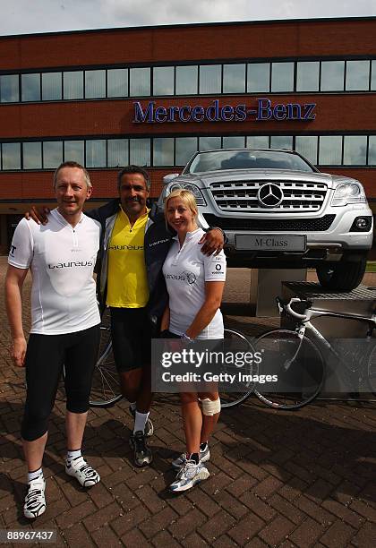 Laureus World Sports Academy member Daley Thompson poses with Stacey Penn and John Reed, employee's of Mercedes-Benz at the Mercedes-Benz UK HQ...