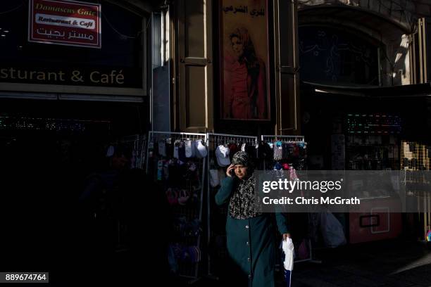 Woman speaks on the phone in front of a shop outiside the Damascus Gate in the Old City on December 10, 2017 in Jerusalem, Israel. In an already...