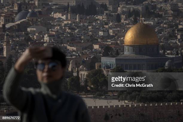 Tourist takes a selfie in front of the Al-Aqsa Mosque on December 10, 2017 in Jerusalem, Israel. In an already divided city, U.S. President Donald...