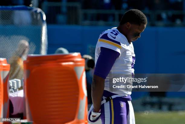 Teddy Bridgewater of the Minnesota Vikings stands by himself near the team bench for the national anthem during their game against the Carolina...