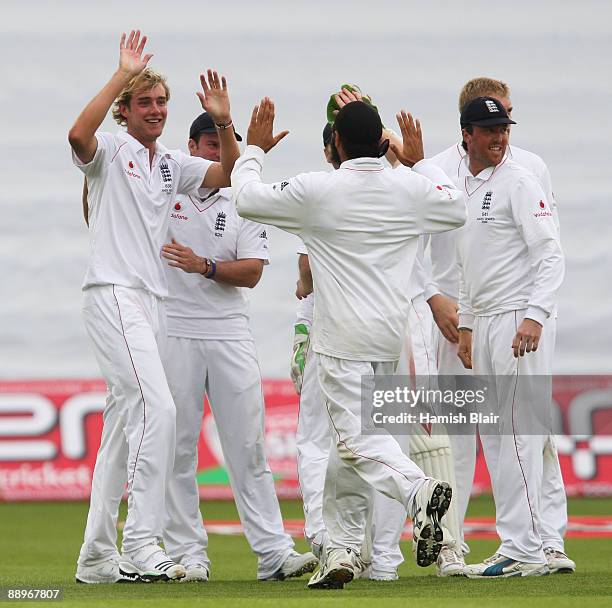 Stuart Broad of England celebrates the wicket of Michael Clarke of Australia with team mates during day three of the npower 1st Ashes Test Match...