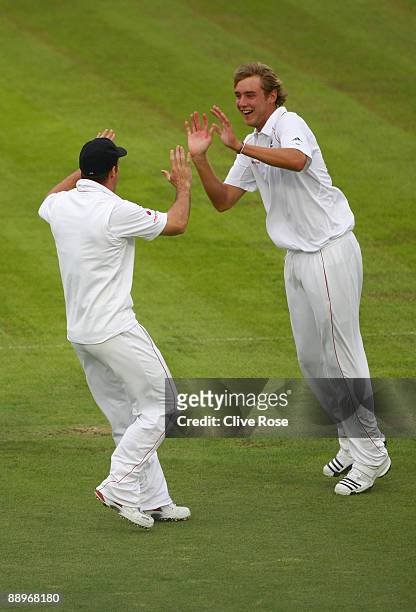 Stuart Broad of England celebrates the wicket of Michael Clarke of Australia during day three of the npower 1st Ashes Test Match between England and...