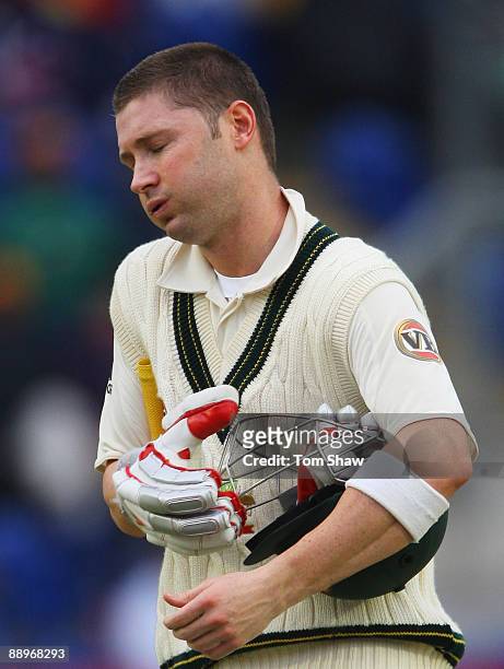 Michael Clarke of Australia walks back after being dismissed by Stuart Broad of England during day three of the npower 1st Ashes Test Match between...
