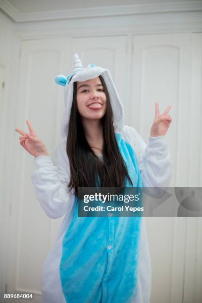 portrait of young brunette in unicorn  hooded onesie - babygro stock pictures, royalty-free photos & images