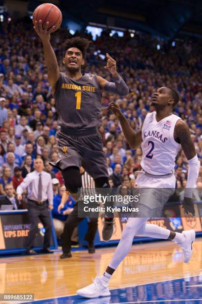 Dedric Lawson of the Kansas Jayhawks drives past Rob Edwards of the Arizona State Sun Devils in the second half at Allen Fieldhouse on December 10,...