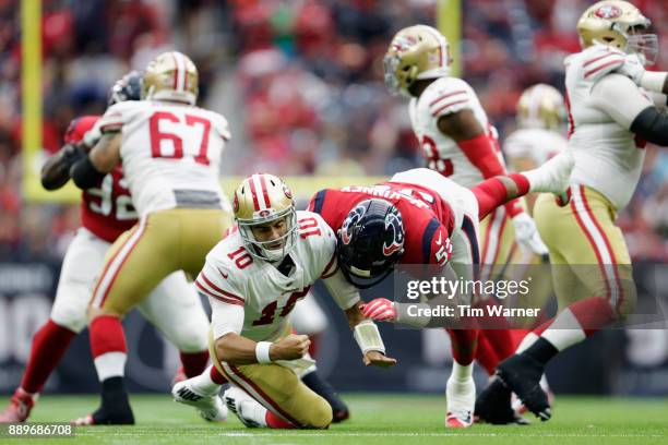 Benardrick McKinney of the Houston Texans drives Jimmy Garoppolo of the San Francisco 49ers to the ground after throwing a pass in the third quarter...