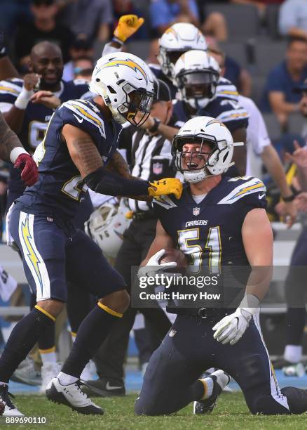 Kyle Emanuel of the Los Angeles Chargers celebrates his interception with Trevor Williams during the first quarter against the Washington Redskins at...