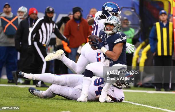 Dak Prescott of the Dallas Cowboys is tackled by Dalvin Tomlinson of the New York Giants during their game at MetLife Stadium on December 10, 2017 in...