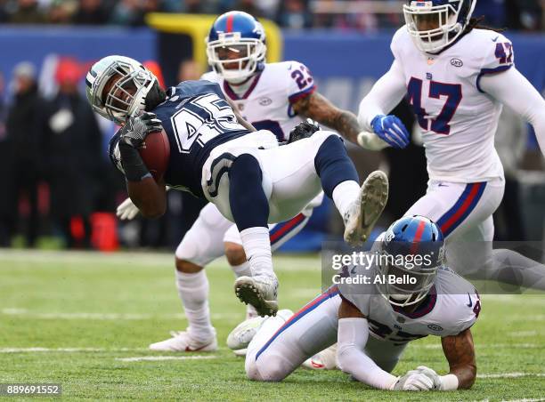 Rod Smith of the Dallas Cowboys is tackled by Ross Cockrell of the New York Giants during their game at MetLife Stadium on December 10, 2017 in East...