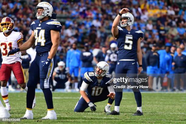 Travis Coons and Kellen Clemens of the Los Angeles Chargers watch a fiel goal to take a 3-0 lead over the Washington Redskins at StubHub Center on...