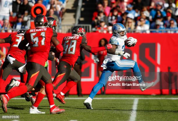 Running back Theo Riddick of the Detroit Lions slips a tackle by middle linebacker Kwon Alexander of the Tampa Bay Buccaneers as he rushes for a...