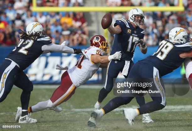 Linebacker Ryan Kerrigan of the Washington Redskins gets to quarterback Philip Rivers of the Los Angeles Chargers and forces an incomplete pass on...