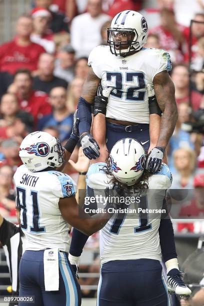 Derrick Henry of the Tennessee Titans celebrates a six yard touchdown with Jonnu Smith and Dennis Kelly against the Arizona Cardinals in the first...