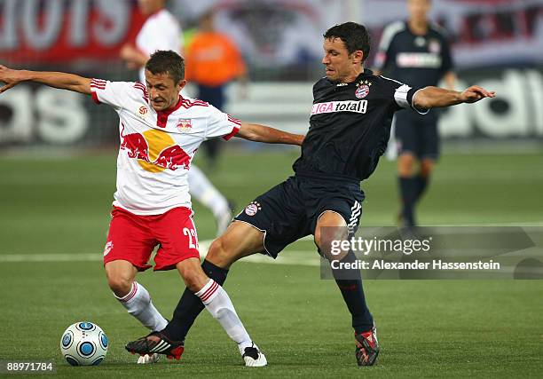 Mark van Bommel of Muenchen battles for the ball with Sasa Ilic of Salzburg during the pre-season friendly match between Red Bull Salzburg and FC...