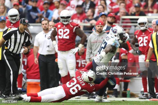 Delanie Walker of the Tennessee Titans runs with the football against Budda Baker of the Arizona Cardinals in the first half of the NFL game at...