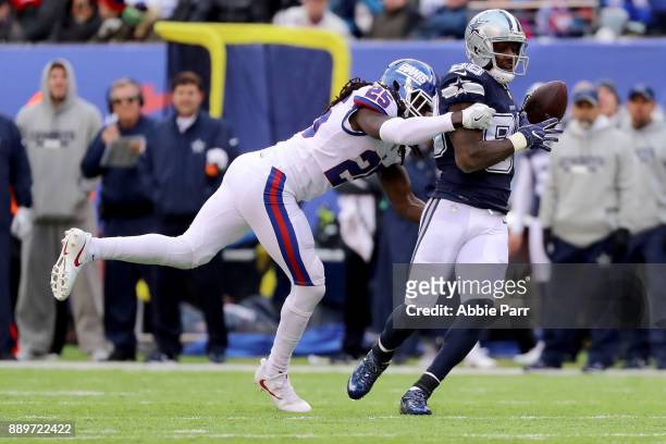 Dez Bryant of the Dallas Cowboys catches the ball against Brandon Dixon of the New York Giants for what would be a 50 yard touchdown in the third...