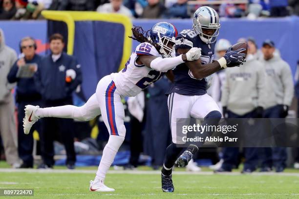 Dez Bryant of the Dallas Cowboys catches the ball against Brandon Dixon of the New York Giants for what would be a 50 yard touchdown in the third...