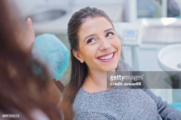 beautiful woman at dentist office - dentists chair stock pictures, royalty-free photos & images