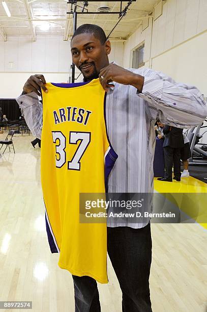 Ron Artest of the Los Angeles Lakers poses with his jersey after the press conference announcing his signing with the team on July 8, 2009 at the...