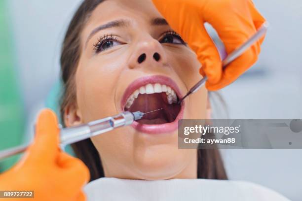 dentist giving anesthesia to the patient - anesthesia stock pictures, royalty-free photos & images