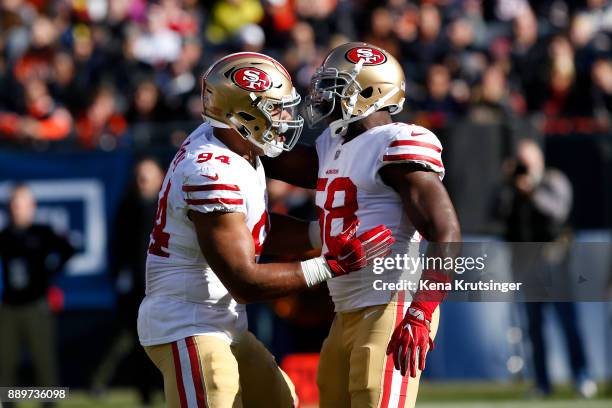 Solomon Thomas and Elvis Dumervil of the San Francisco 49ers celebrate after Dumervil sacked quarterback Mitchell Trubisky of the Chicago Bears in...