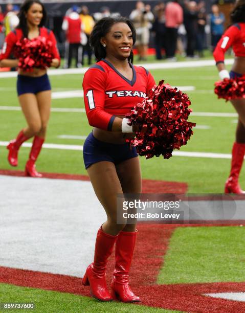 Honorary Houston Texans cheerleader and Olympic gold medalist Simone Biles performs with the cheerleaders during the game against the San Francisco...