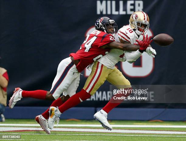 Johnathan Joseph of the Houston Texans knocks the ball away from Louis Murphy of the San Francisco 49ers in the second half at NRG Stadium on...