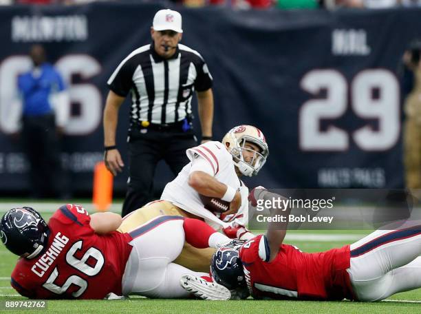 Jimmy Garoppolo of the San Francisco 49ers is sacked by Brian Cushing of the Houston Texans and Zach Cunningham in the second half at NRG Stadium on...