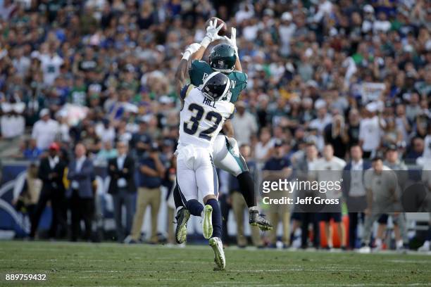 Trey Burton of the Philadelphia Eagles makes a catch over Troy Hill of the Los Angeles Rams during the second quarter of the game at the Los Angeles...