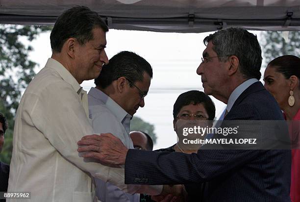 Carlos Lopez , member of the delegation representing interim Honduran leader Roberto Micheletti, shakes hands with Costa Rican President Oscar Arias...